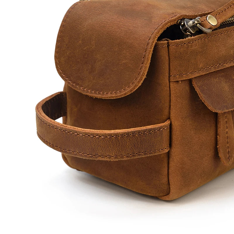 Brown leather bag with a strap on a white background