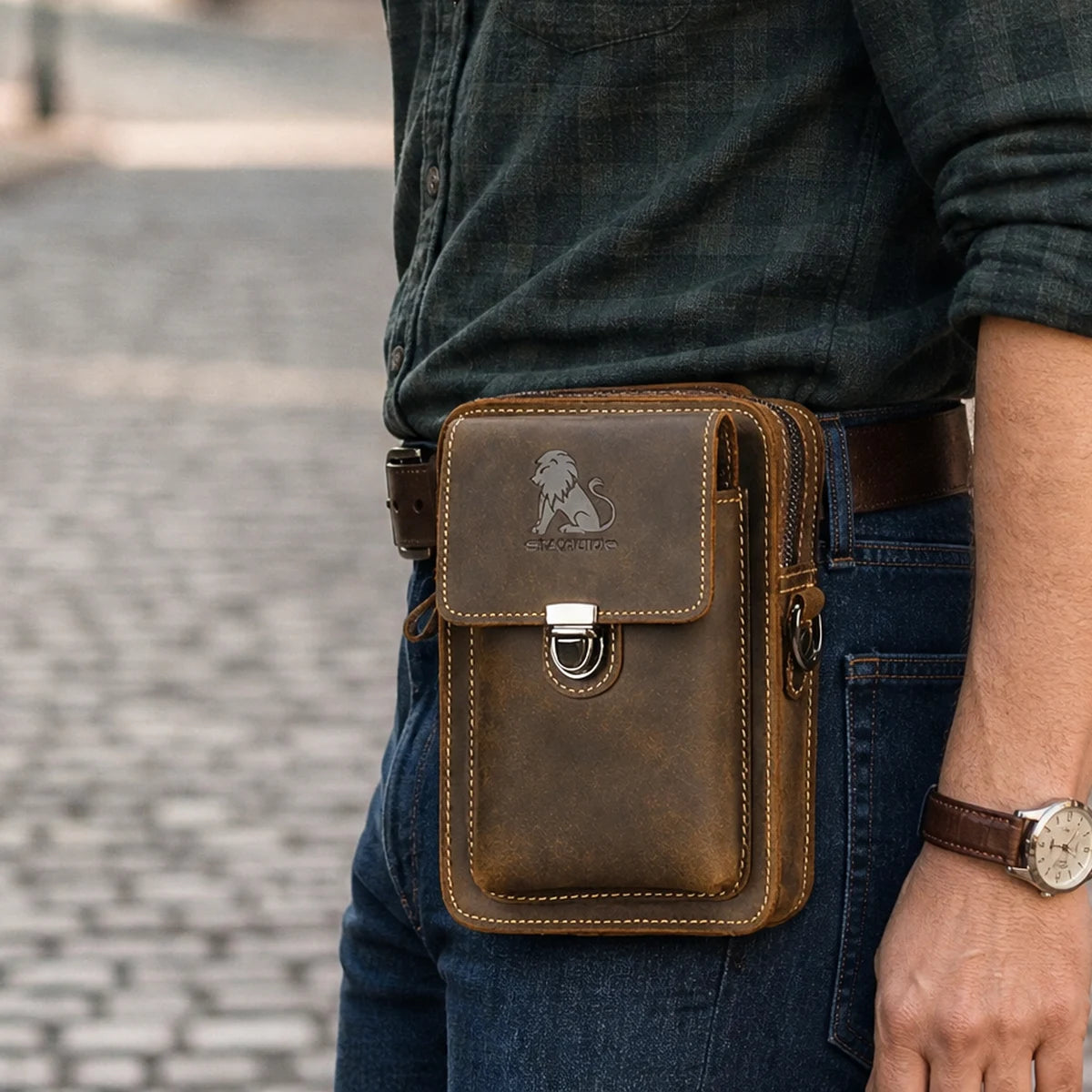 Brown leather phone holster clipped on a belt, side view