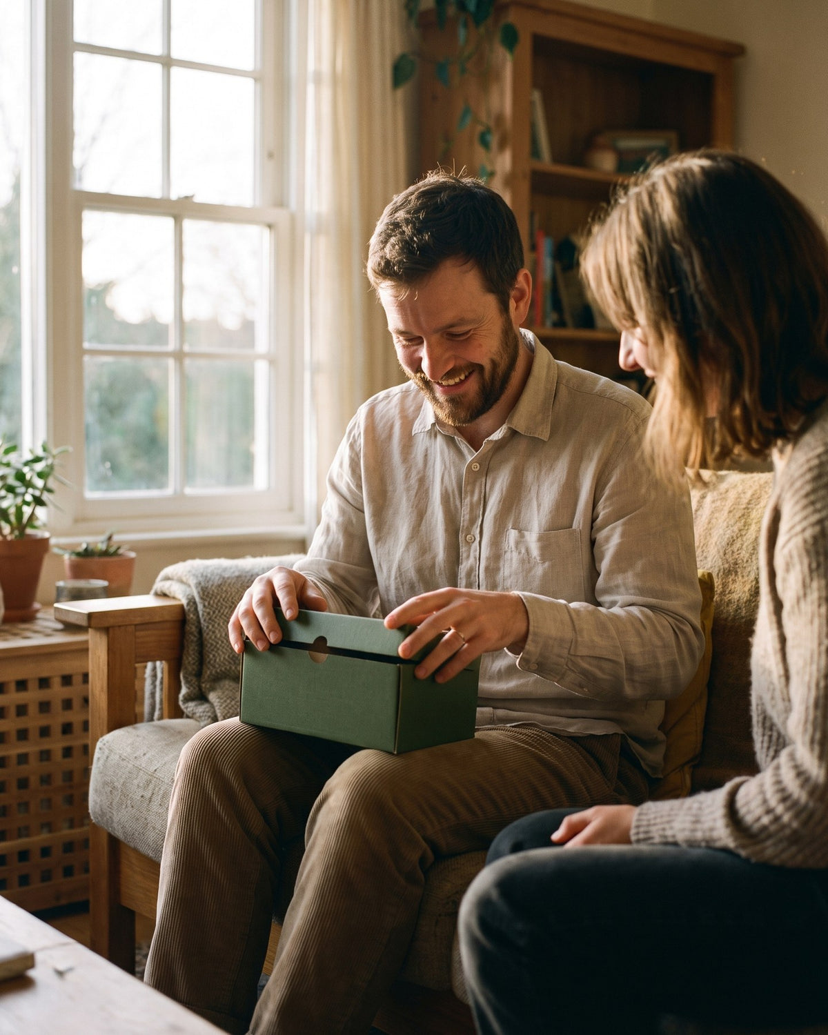 A man receiving a small green gift box