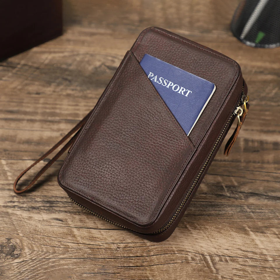 Brown travel wallet with a passport on a wooden surface