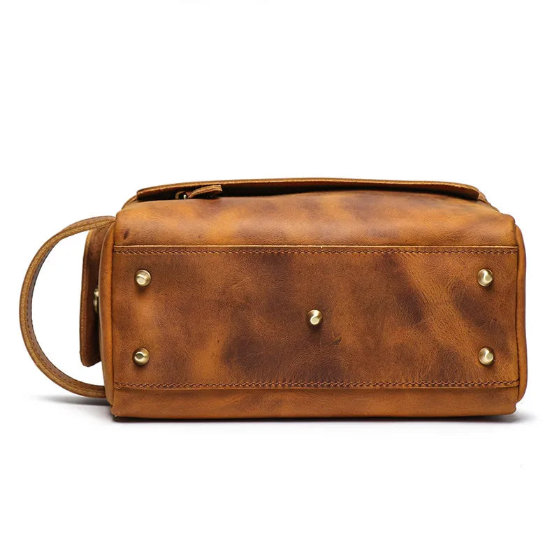 Brown leather bag with gold studs on a white background