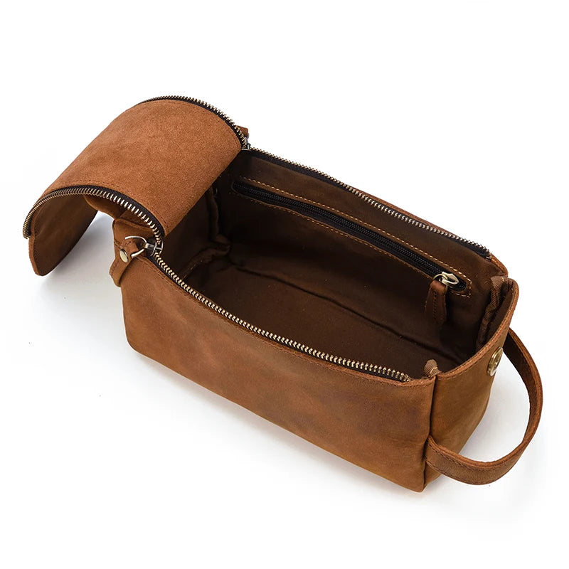 Brown leather toiletry bag with open top on a white background