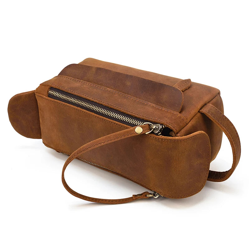 Brown leather bag with a strap on a white background