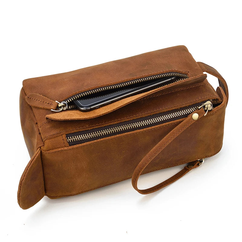 Brown leather handbag with a shoulder strap on a white background