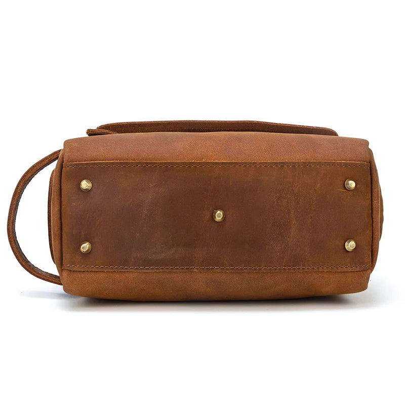 Brown leather bag with gold studs on a white background