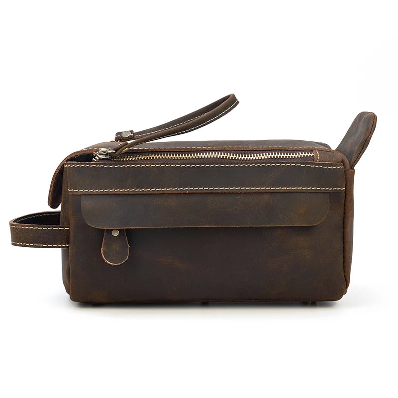 Brown leather bag with a strap on a white background