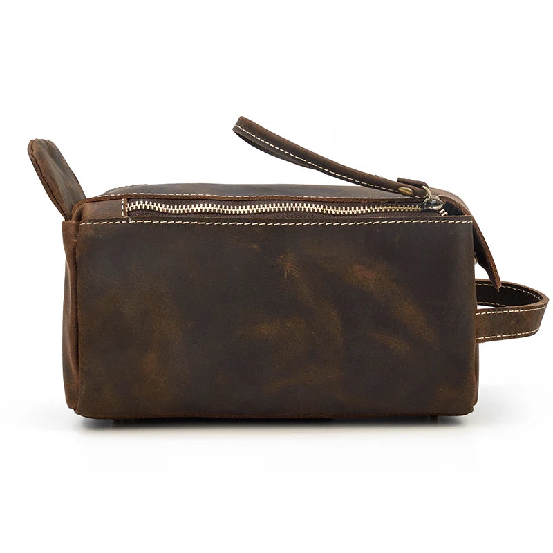 Brown leather bag with a strap on a white background