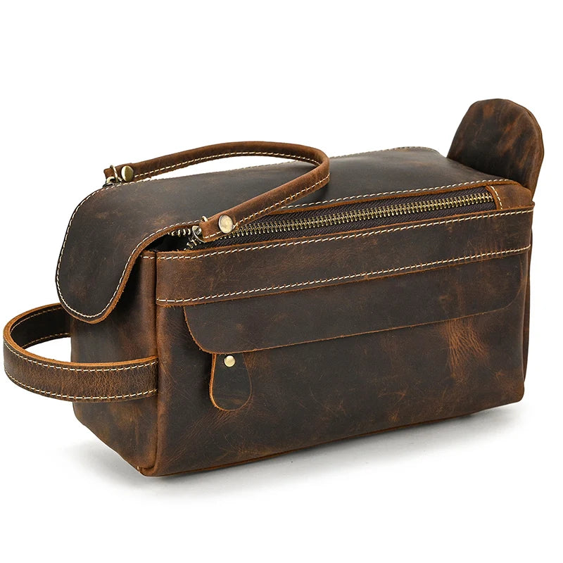 Brown leather toiletry bag with handle and zipper on a white background