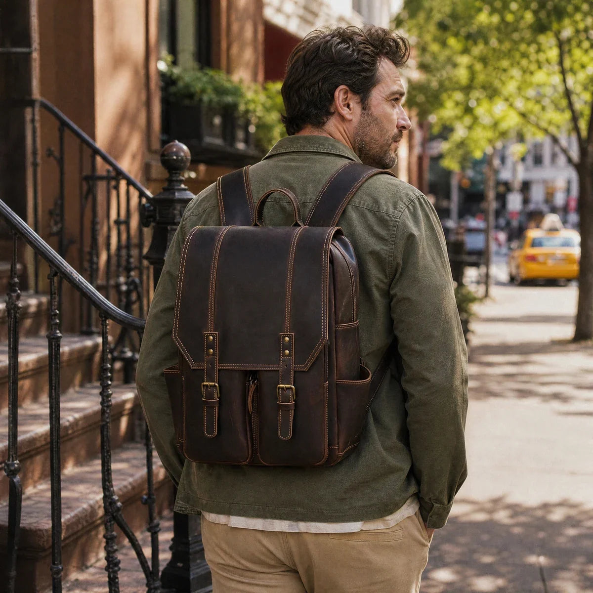Man wearing a crazy horse leather flap backpack, seen from behind